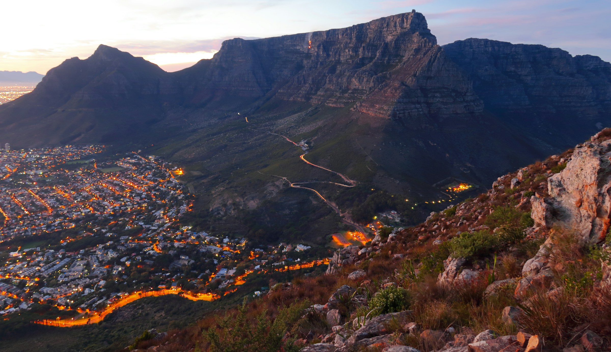 Table Mountain and the lights of Cape Town at dusk, seen from Lion’s Head